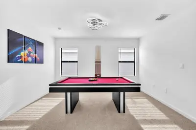 a ping pong table in a room with a pink floor at Royal Palm Gateway - Spacious Family Retreat in Sunny Homestead in Homestead