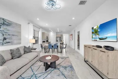 a living room with a couch and a table at Royal Palm Gateway - Spacious Family Retreat in Sunny Homestead in Homestead