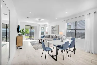a living room with a table and chairs and a couch at Royal Palm Gateway - Spacious Family Retreat in Sunny Homestead in Homestead