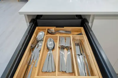 a drawer filled with silver utensils in a kitchen at New Spacious 3BR Apt With Rooftop Pool 2 Parking in Hollywood