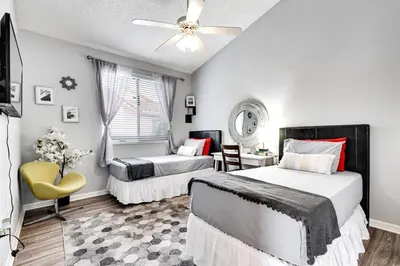 a bedroom with two beds and a ceiling fan at 2 Br 2 Bath Waterfront Apt Walking To Beach in Hallandale Beach