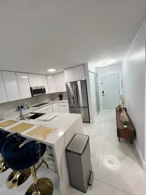 a white kitchen with a sink and a counter at Miami City Escape in Hialeah