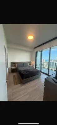 a bedroom with a large bed and a large window at New 1Bed 1 bath Ocean view in Miami Beach