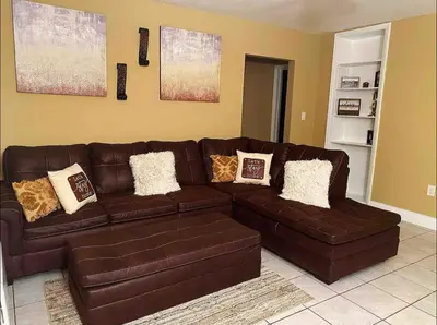 a brown leather couch in a living room at Lovely 2 Bedroom Condo With Free Parking & Wifi!! in Sunrise