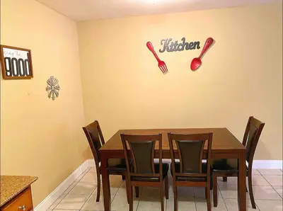 a dining room with a table and baseball bats on the wall at Lovely 2 Bedroom Condo With Free Parking & Wifi!! in Sunrise