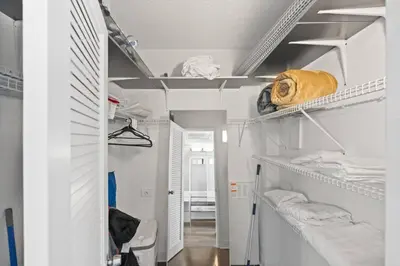 a room with white shelves and a hallway at SUNNY ISLES 4BR Pool & Beach Access in Sunny Isles Beach