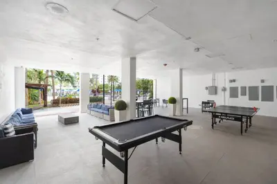 a large room with two ping pong tables in it at SUNNY ISLES 4BR Pool & Beach Access in Sunny Isles Beach