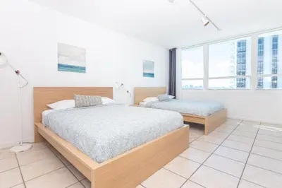 a bedroom with two beds and a large window at UNIT #1108 Castle Beach Club Condominium in Miami Beach