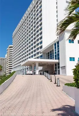 a large building with a parking lot in front of it at UNIT #1108 Castle Beach Club Condominium in Miami Beach