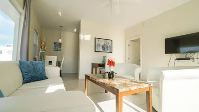a living room with a couch and a table at Soleado Hotel in Fort Lauderdale