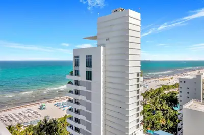 a tall white building with the beach in the background at Luxury Oceanview Suite at the Fontainebleau Miami Beach with Balcony, King & Sofa Bed in Miami Beach