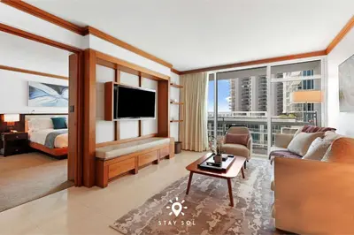 a large living room with a bed and a television at Spectacular 1-Bedroom Apartment Beach view in Miami Beach