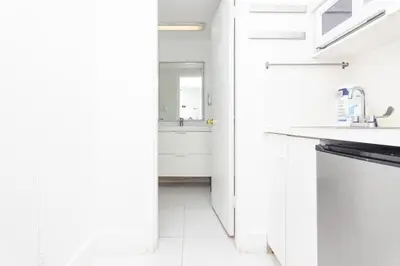 a white kitchen with a sink and a dishwasher at UNIT #908 Castle Beach Club Condominium in Miami Beach