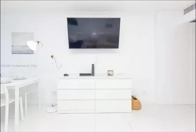 a white bathroom with a sink and a desk at UNIT #908 Castle Beach Club Condominium in Miami Beach