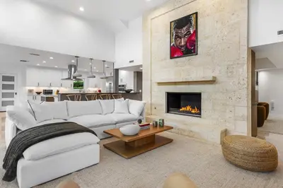 a living room with a white couch and a fireplace at Riviera Reserve by Stay Awhile Villas in Fort Lauderdale