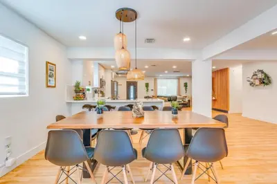 a dining room with a large wooden table and chairs at Fox Garden Luxury Boho Near Downtown & Beach home in Fort Lauderdale