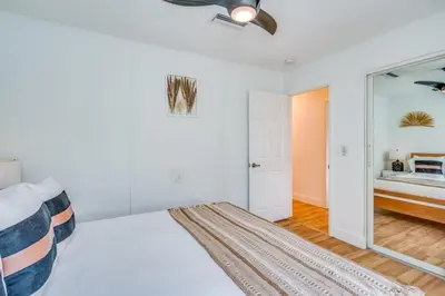 a white bedroom with a bed and a mirror at Fox Garden Luxury Boho Near Downtown & Beach home in Fort Lauderdale