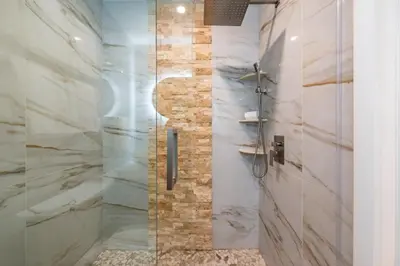 a bathroom with a shower with a glass door at Fox Garden Luxury Boho Near Downtown & Beach home in Fort Lauderdale
