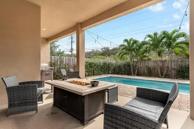 a backyard with a pool and a table and chairs at Fox Sonata Downtown Pool House home in Fort Lauderdale