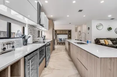 a kitchen with a long counter and a couch at Fox Sonata Downtown Pool House home in Fort Lauderdale
