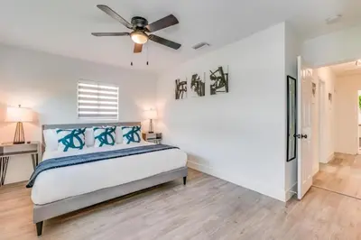 a bedroom with a bed and a ceiling fan at Friendly Fox Luxury Pool & Spa - Near DT & Beach home in Fort Lauderdale