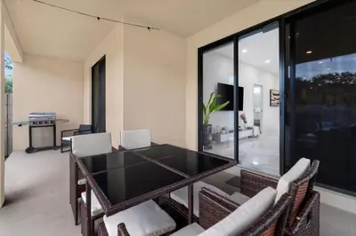 a dining room with a black table and chairs at Golden Fox Downtown Pool House home in Fort Lauderdale