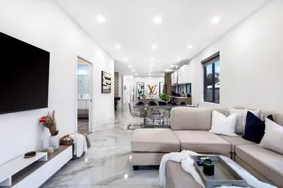 a living room with a couch and a tv at Golden Fox Downtown Pool House home in Fort Lauderdale