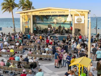 a crowd of people at a concert on the beach at Designer 2br, king-size bed, 5mins to the beach J1 in Hollywood