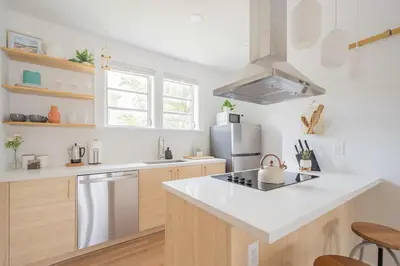 a kitchen with white counter tops and a refrigerator at Stylish 2br apt, 5 mins to the BEACH J2 in Hollywood