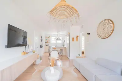 a living room with a white couch and a tv at Stylish 2br apt, 5 mins to the BEACH J2 in Hollywood