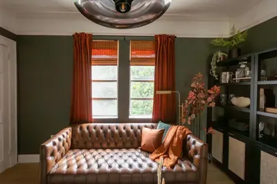 a leather couch in a living room with a window at Cozy 2br 5 mins drive to the beach j6 in Hollywood