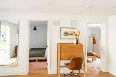 a bedroom with a mirror and a desk and a bed at Designer Gem Condo - 5 Mins to Sand, Playground, Tennis, Free Parking in Hollywood