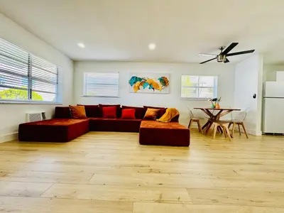 a living room with a red couch and a table at Modern Hollywood Beach Retreat 2BDx2BTH - Games, WiFi, AC in Hollywood