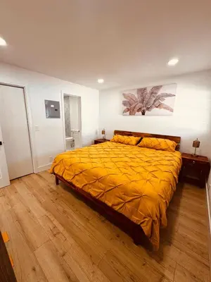 a bedroom with a bed with a yellow comforter at Modern Hollywood Beach Retreat 2BDx2BTH - Games, WiFi, AC in Hollywood