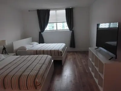 a hotel room with two beds and a flat screen tv at Ocean reserve 2 bedroom plus den in Sunny Isles Beach