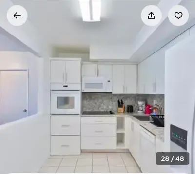 a white kitchen with white cabinets and white appliances at Ocean reserve 2 bedroom plus den in Sunny Isles Beach