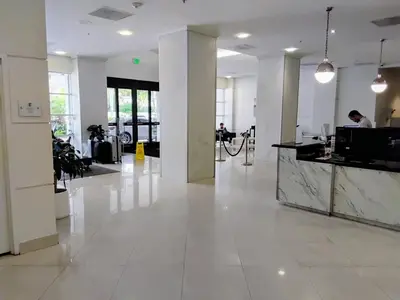 a large white lobby with a counter in a building at Ocean reserve 2 bedroom plus den in Sunny Isles Beach