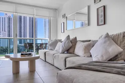 a living room with a couch and a table at Resort at Sunny Isles Beach with Ocean view in Sunny Isles Beach