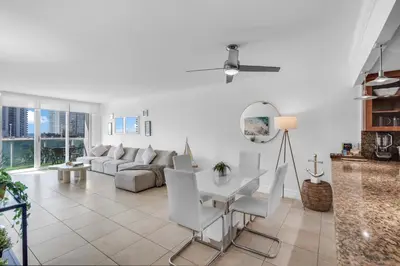 a living room with a couch and a table and chairs at Resort at Sunny Isles Beach with Ocean view in Sunny Isles Beach