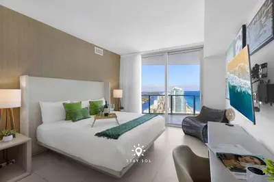 a bedroom with a large bed and a large window at Stunning 1BR Apt With Ocean View Balcony in Hollywood