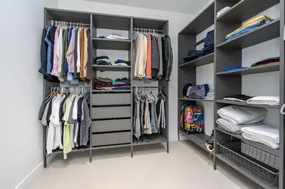 a walk in closet with black shelving at Luxe Pool House in North Miami Perfect for Groups in North Miami Beach