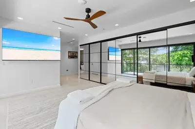 a bedroom with a bed and a ceiling fan at Absolut Luxe 5 Bed Villa with Pool- Great for Group in North Miami Beach