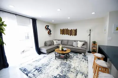 a living room with a couch and a table at The Hamptons Hideaway in Hollywood