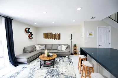 a living room with a couch and a table at The Hamptons Hideaway in Hollywood