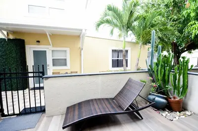 a chair sitting on a porch in front of a house at The Hamptons Hideaway in Hollywood