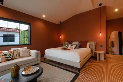 a bedroom with a large bed and a couch at Maison Felix in Miami Beach