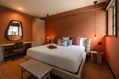 a bedroom with a large bed and a mirror at Maison Felix in Miami Beach