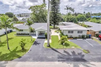 an aerial view of a house with a parking lot at The Pines Hideaway-Your Home Away from Home in Fort Lauderdale