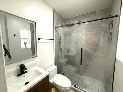 a bathroom with a shower and a toilet and a sink at The Pines Hideaway-Your Home Away from Home in Fort Lauderdale