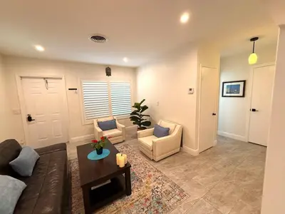 a living room with a couch and chairs and a table at The Pines Hideaway-Your Home Away from Home in Fort Lauderdale